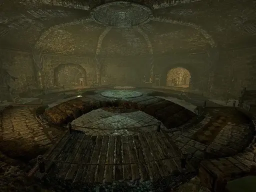 A large chamber within a sewer system, taken from the "Cistern" location in Skyrim.