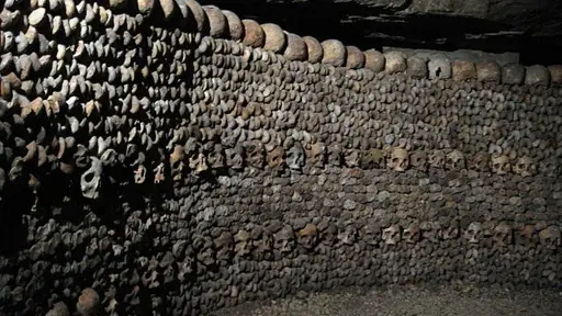 A wall with skulls embedded into it, from the catacombs of Paris