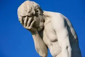 A facepalming statue of a man.